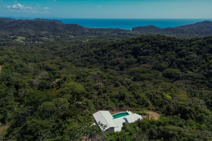 drone view showing the mountains of Casa Blanca home luxury home for sale samara costa rica