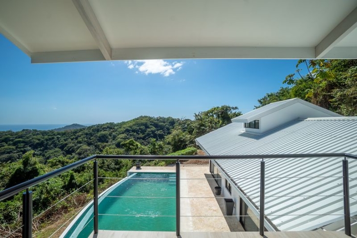 pool and ocean view from balcony of Casa Blanca home luxury home for sale samara costa rica