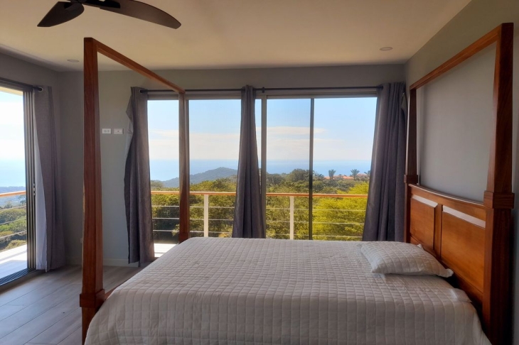 guest bedroom with balcony in Casa Ying Yang high-end home for sale samara costa rica