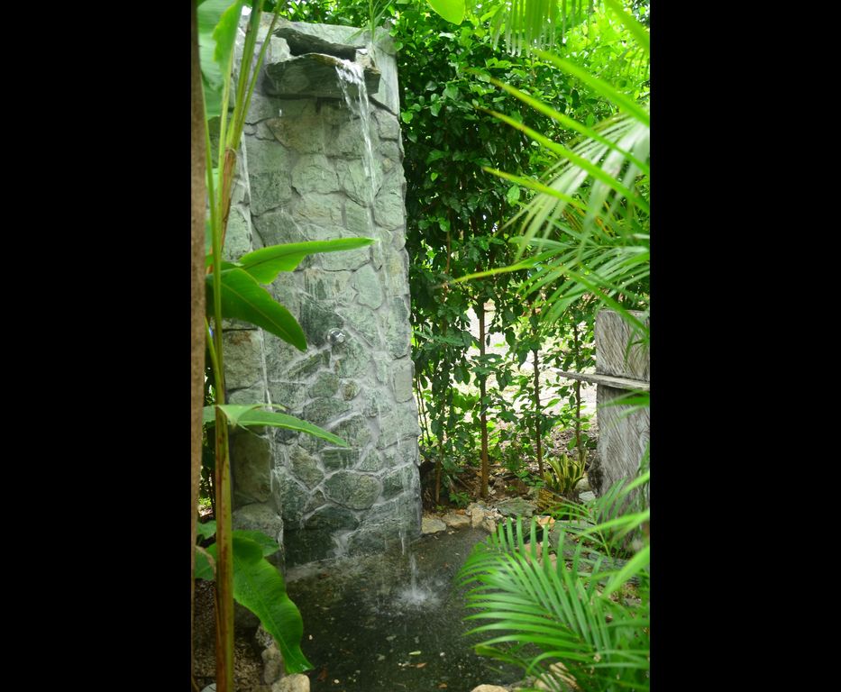 Outdoor stone shower at Casa La Isla, rental income property for sale at Samara Beach, Costa Rica