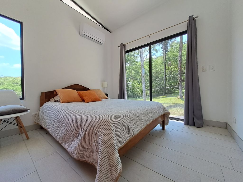 King size bed bedroom of Casa Jungla Tranquila, home for sale at Samara Beach, Guanacaste, Costa Rica
