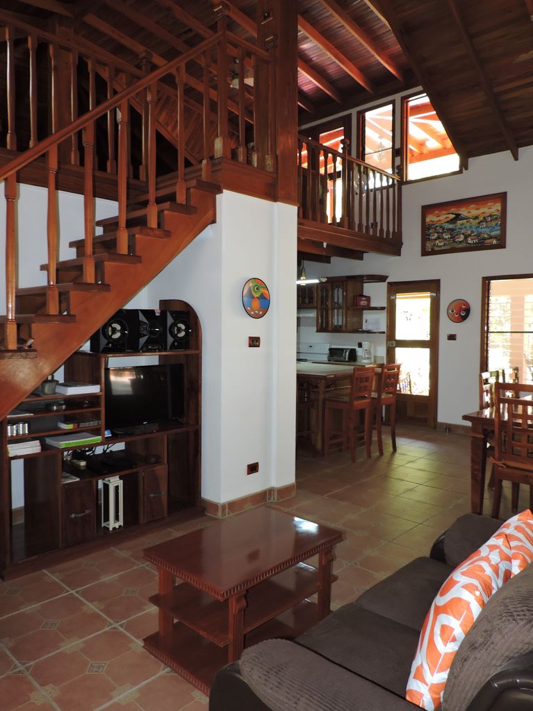 wooden ceilings and staircases in living room of of Casa Mariposa, home for sale at Samara Beach, Guanacaste, Costa Rica