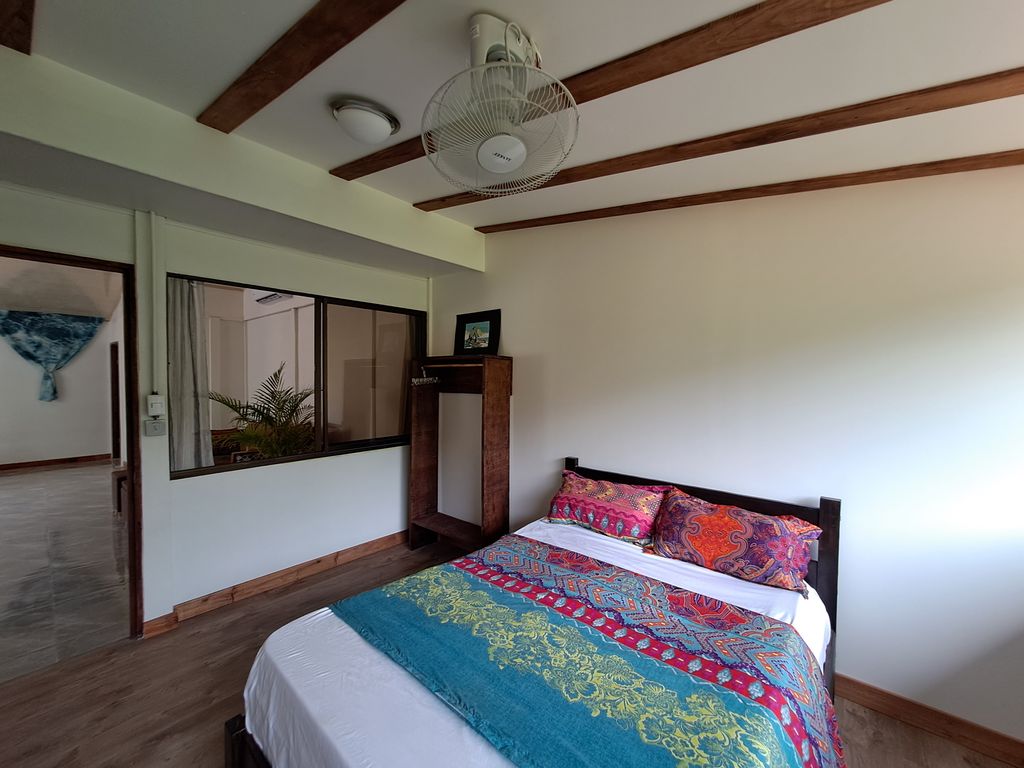 Nice colorful bed decoration of Casa Verde house for sale at Samara, Guanacaste, Costa Rica
