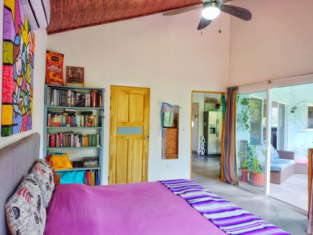 colored masterbedroom at Casa ceiba hotel and rental income property for sale at Samara Beach Guanacaste Costa Rica