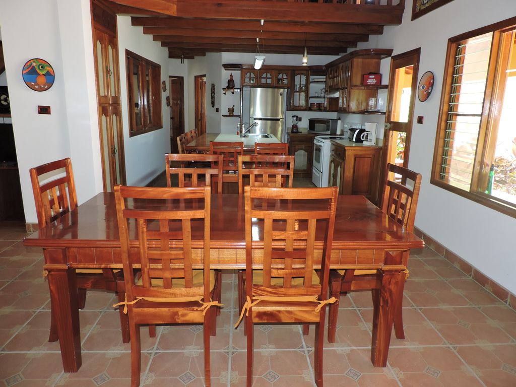 nice wooden dining table and chairs in Casa Mariposa, home for sale at Samara Beach, Guanacaste, Costa Rica