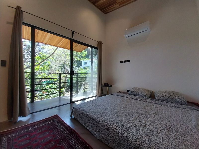 king sized bed with balcony in bedroom of Casa Isa home for sale samara guanacaste costa rica