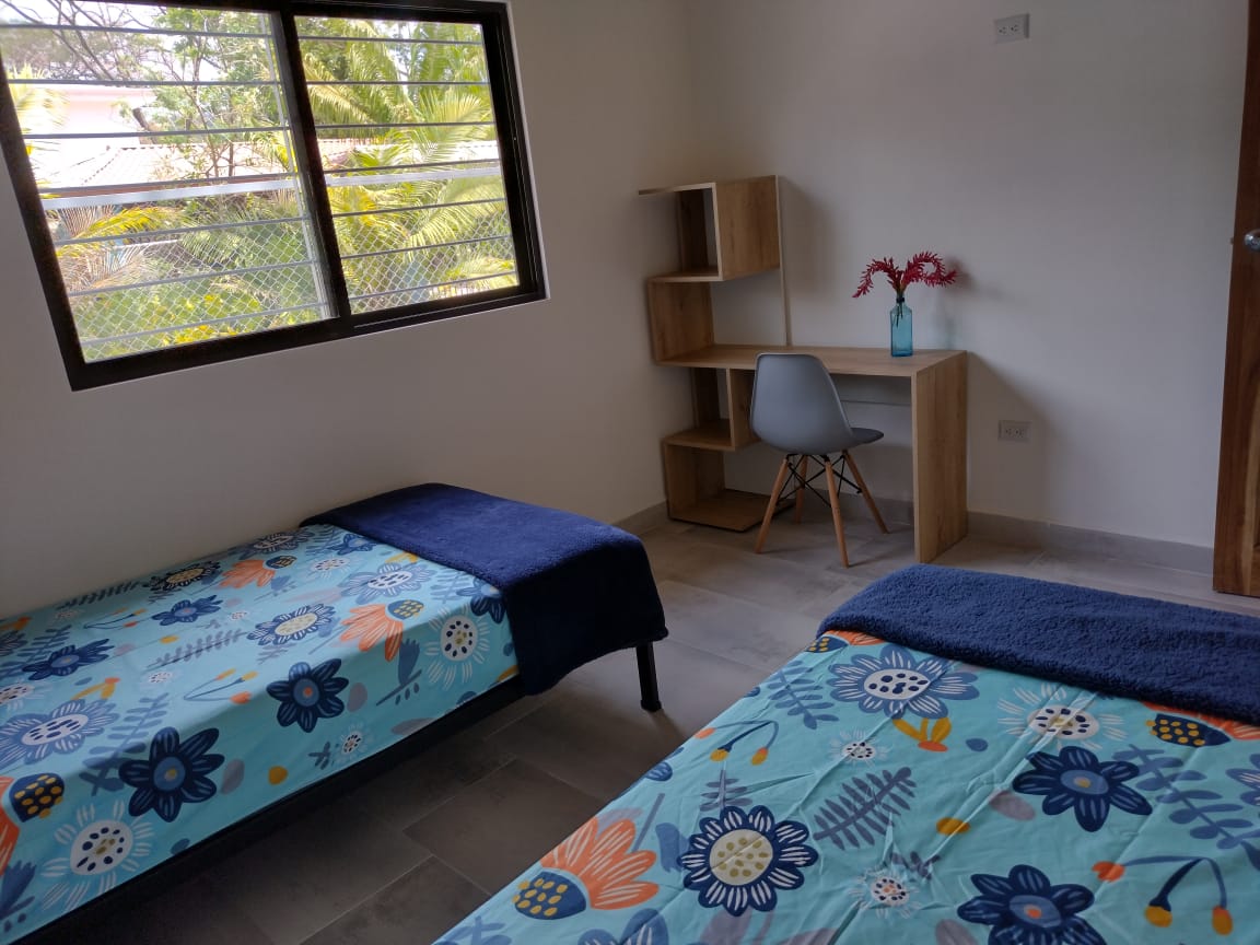two beds with colored bed spreads in Casa espinoza home for sale samara costa rica