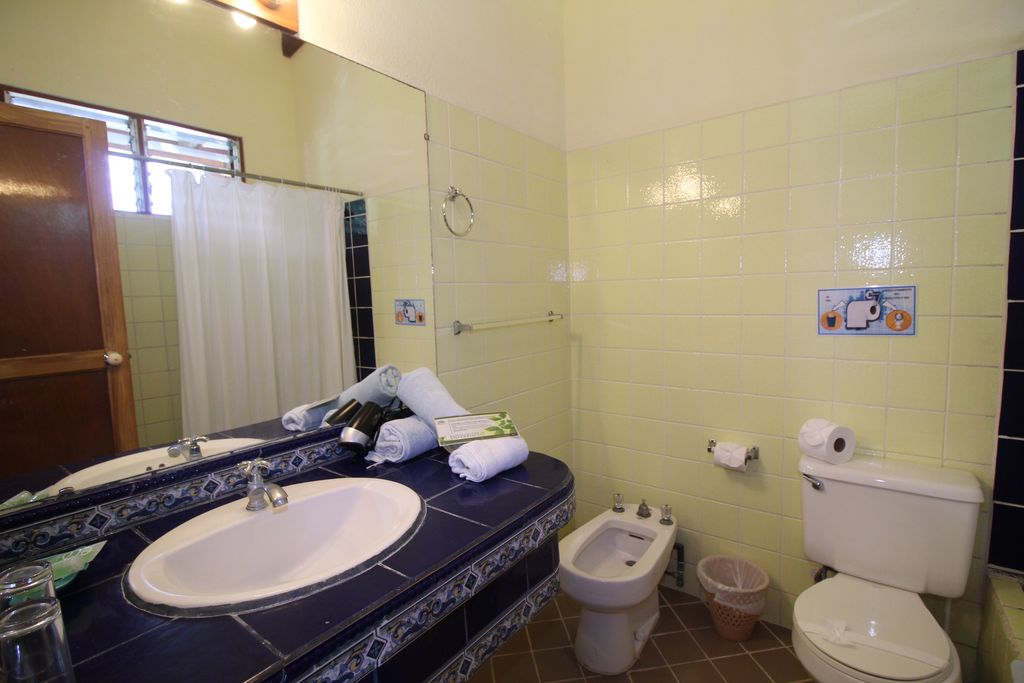 Yellow bathroom of Samara Central Hotel, business for sale at Samara Beach, Guanacaste, Costa Rica