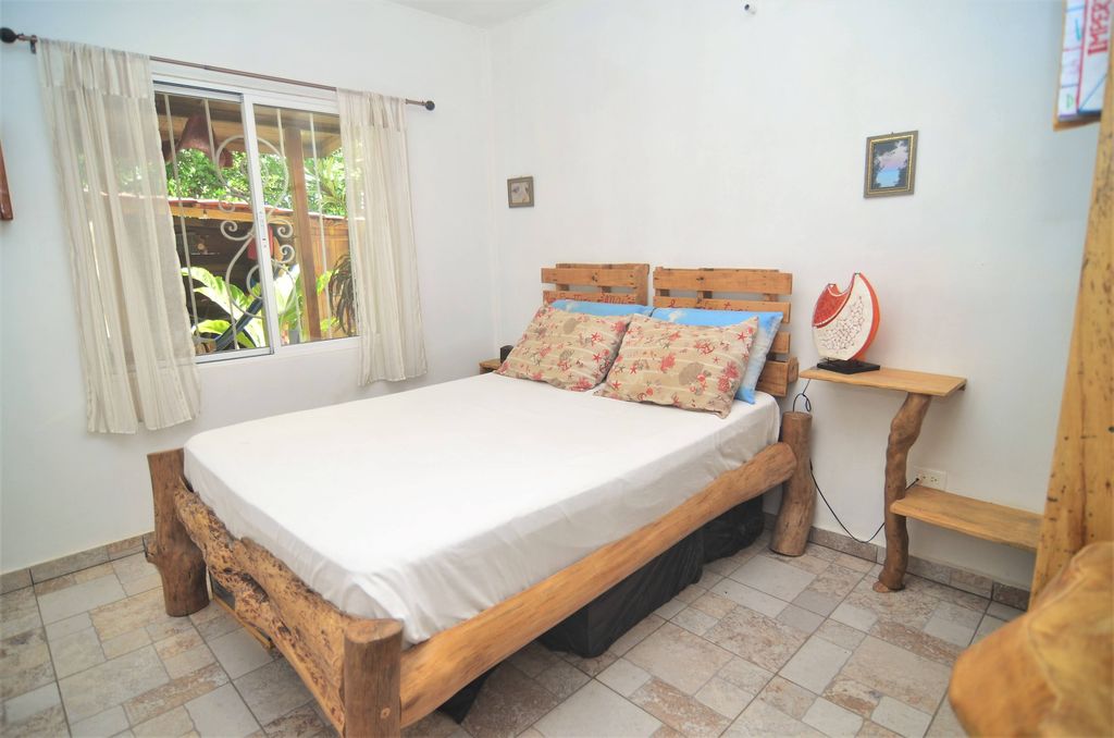 Second bedroom with rustic bed at Casa La Isla, rental income property for sale at Samara Beach, Costa Rica
