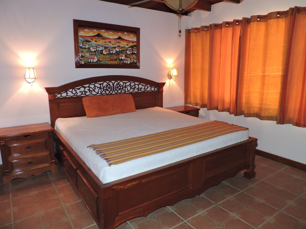 wooden bed in masterbedroom of Casa Mariposa, home for sale at Samara Beach, Guanacaste, Costa Rica