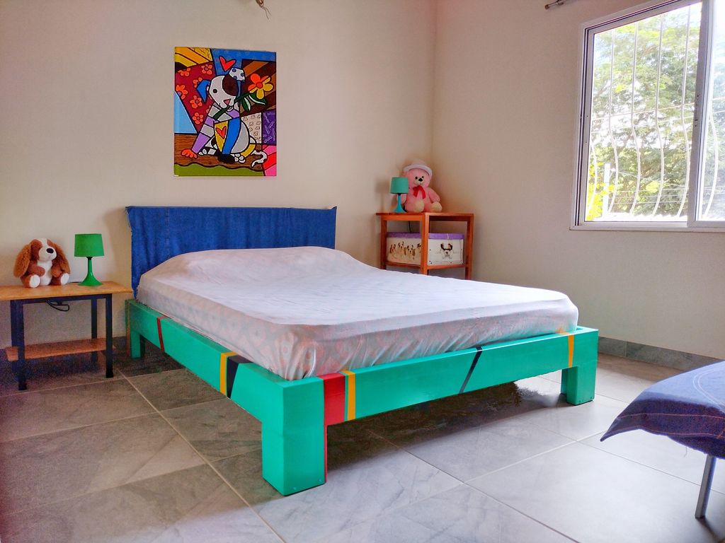 blue frame bed in Casa ceiba hotel and rental income property for sale at Samara Beach Guanacaste Costa Rica