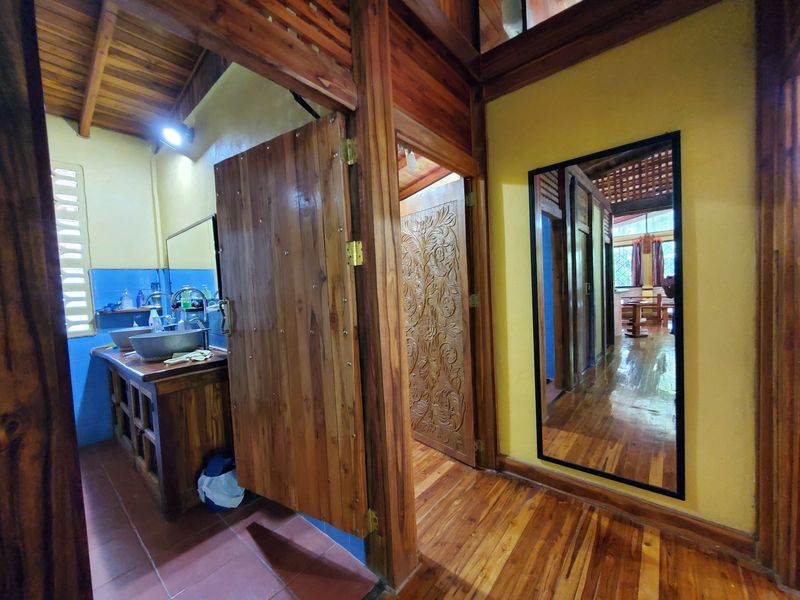 Bathroom with carved wooden doors in Casa Sol, house for sale in Samara, Guanacaste, Costa Rica