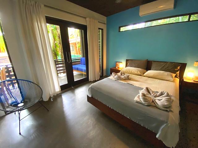 Blue bedroom at The Urban Sanctuary Lodge hotel and rental income property, for sale at Samara Beach, Guanacaste, Costa Rica