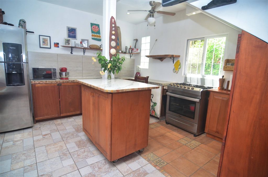 Kitchen with central island on castors at Casa La Isla, rental income property for sale at Samara Beach, Costa Rica