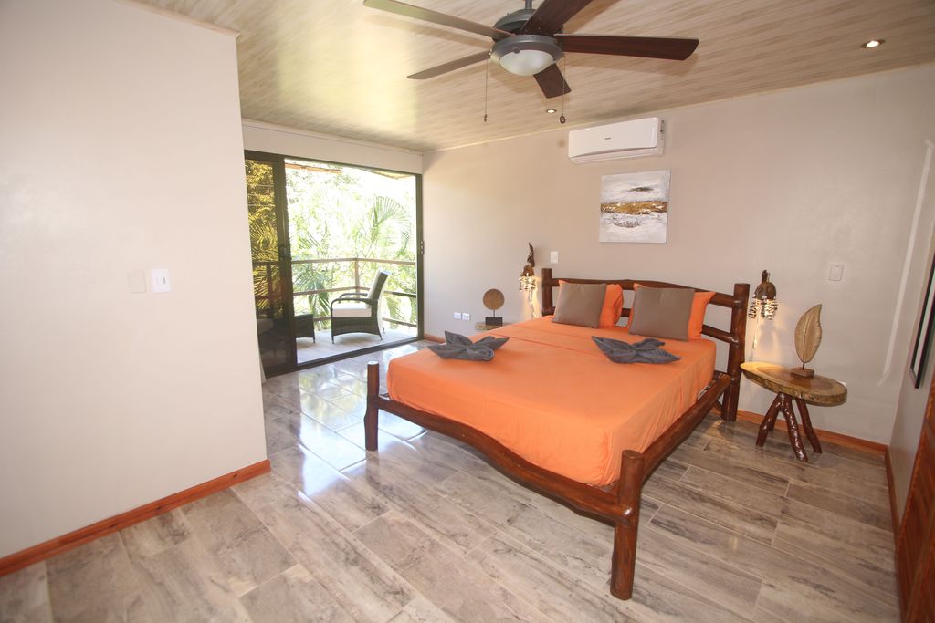Rustic wooden bed of Relax Lodge hotel and rental income property, for sale atSamara Beach, Guanacaste, Costa Rica
