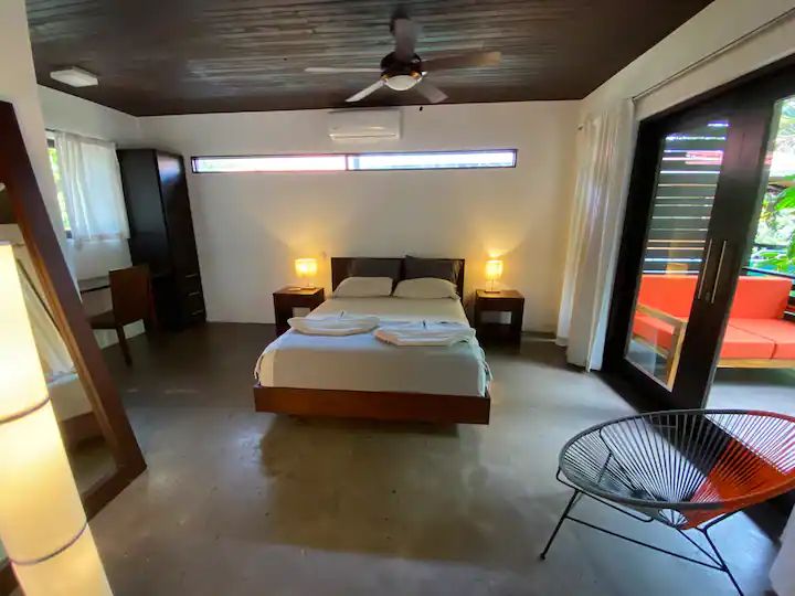 Queen size bed at The Urban Sanctuary Lodge hotel and rental income property, for sale at Samara Beach, Guanacaste, Costa Rica