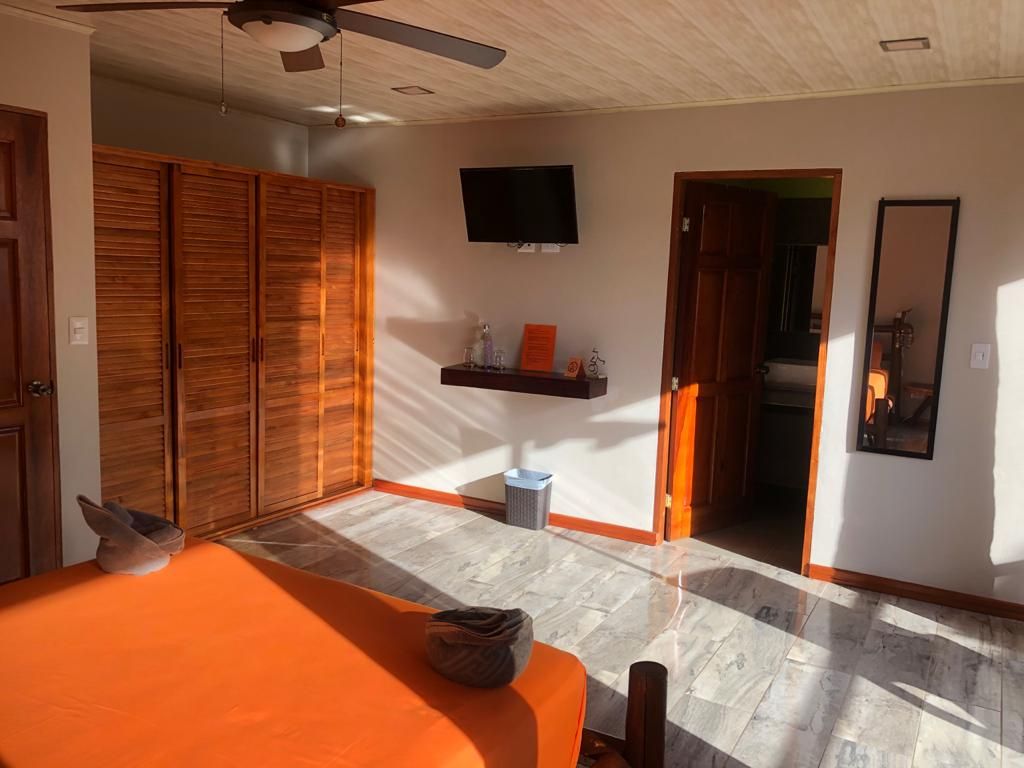 Nice wooden furniture grey tiles on floor of Relax Lodge hotel and rental income property, for sale atSamara Beach, Guanacaste, Costa Rica