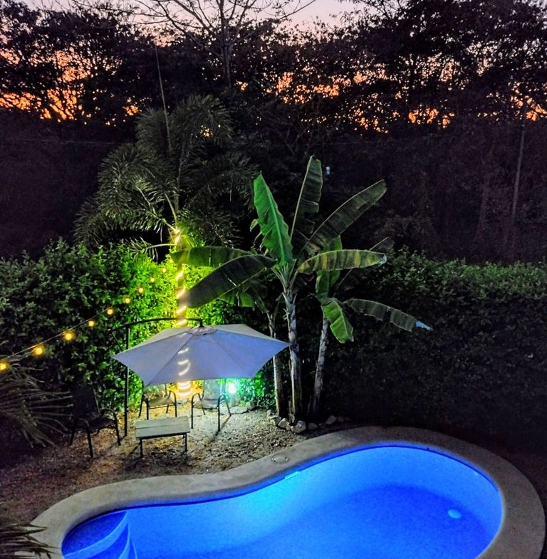 lighted blue pool in the night at Casa ceiba hotel and rental income property for sale at Samara Beach Guanacaste Costa Rica