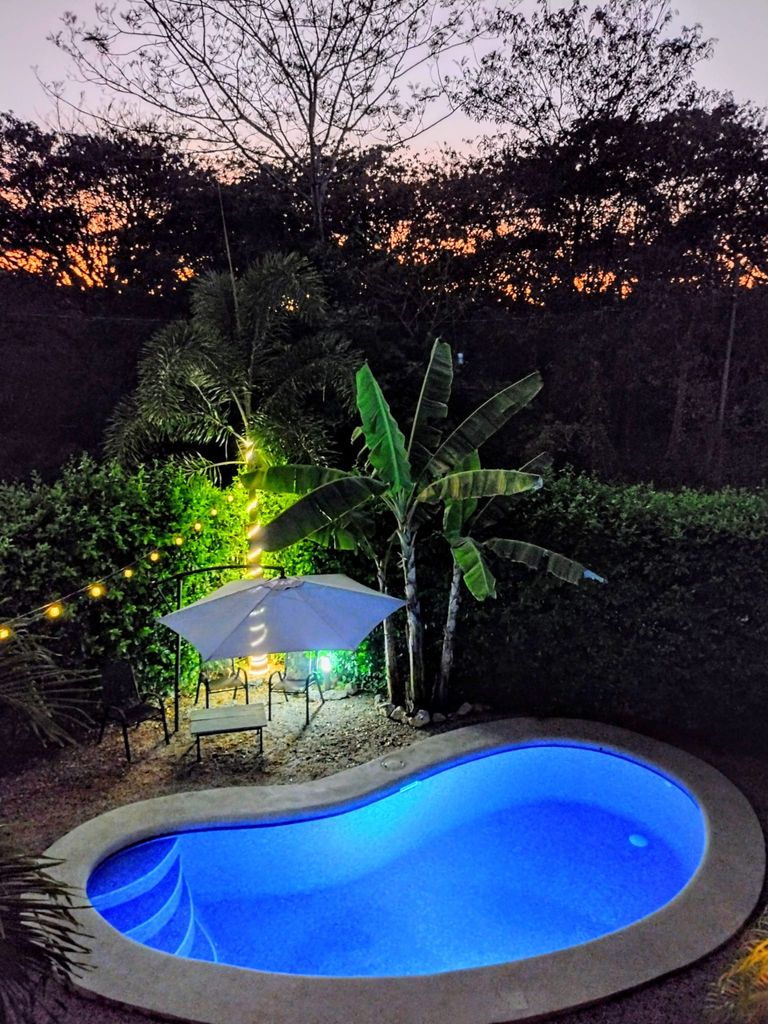 lighted blue pool in the night at Casa ceiba hotel and rental income property for sale at Samara Beach Guanacaste Costa Rica