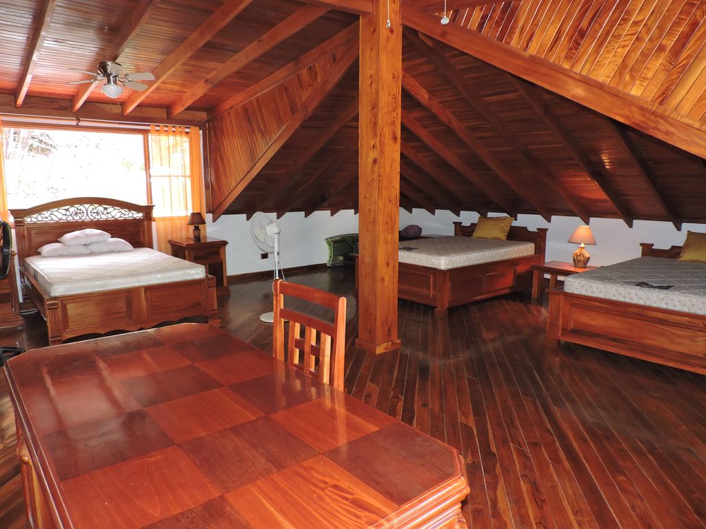 large bedrooms upstairs with beds in Casa Mariposa, home for sale at Samara Beach, Guanacaste, Costa Rica
