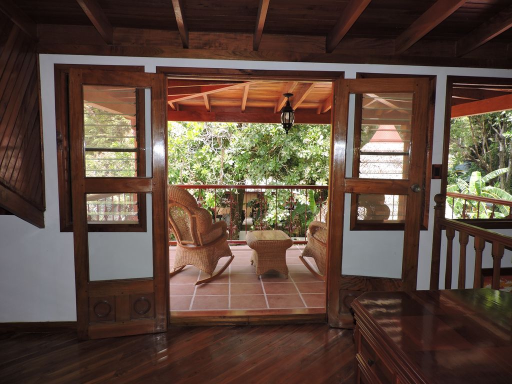 wooden doors open on terrace at Casa Mariposa, home for sale at Samara Beach, Guanacaste, Costa Rica