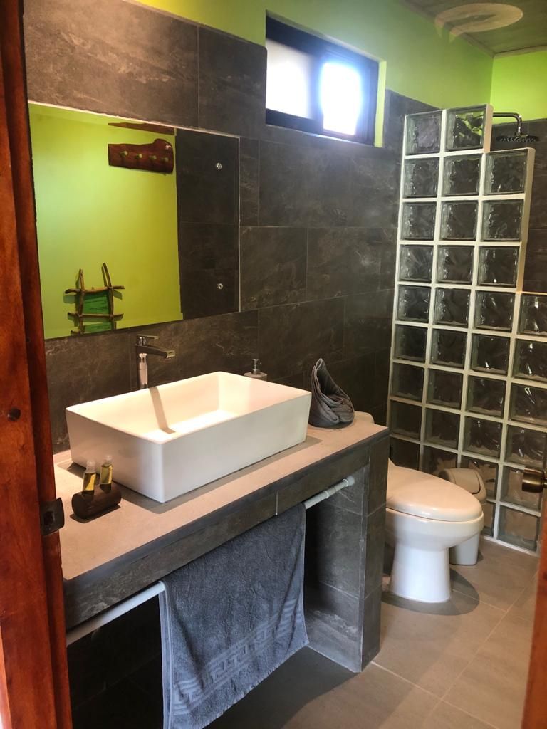 Beautiful washbasin and bright shower of Relax Lodge hotel and rental income property, for sale atSamara Beach, Guanacaste, Costa Rica