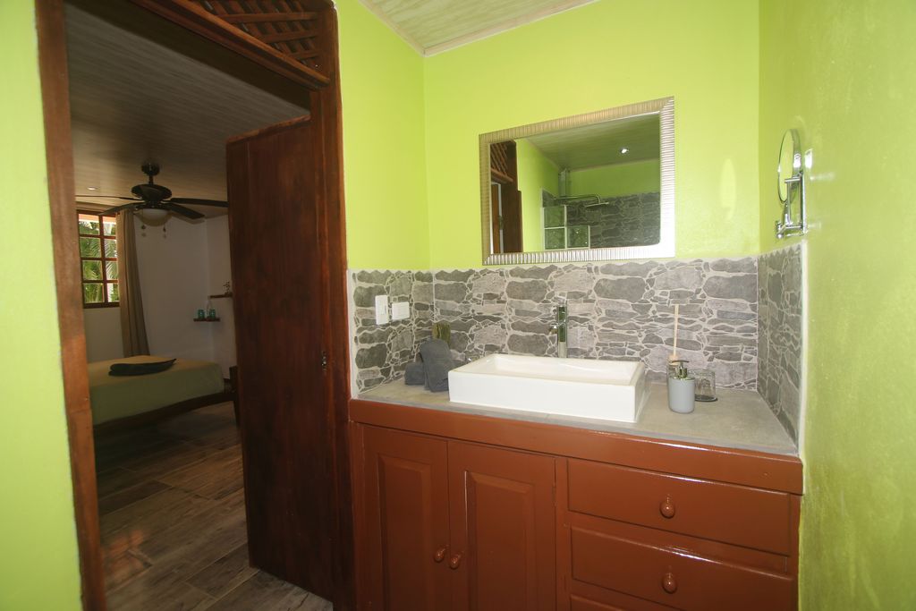 Green bathroom of Relax Lodge hotel and rental income property, for sale atSamara Beach, Guanacaste, Costa Rica
