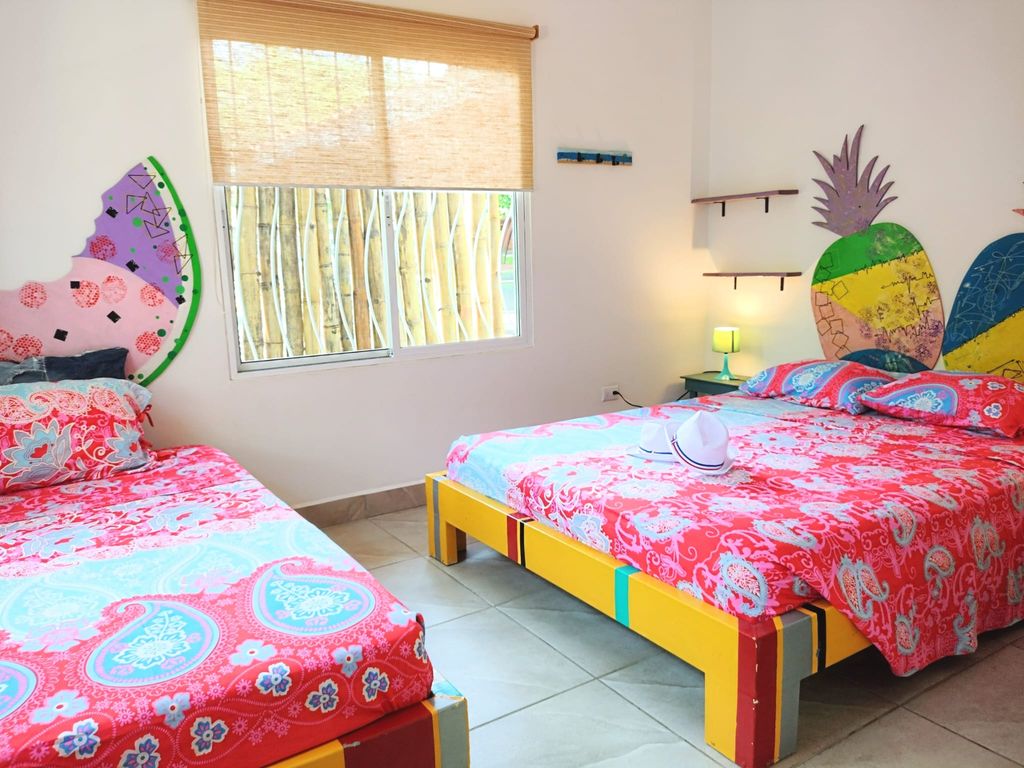 colored beds and decoration at Casa ceiba hotel and rental income property for sale at Samara Beach Guanacaste Costa Rica