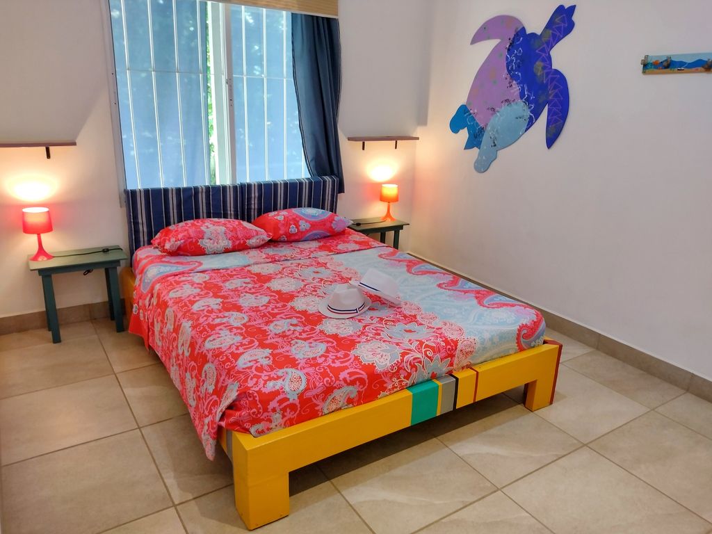 lovely colored bedspread at Casa ceiba hotel and rental income property for sale at Samara Beach Guanacaste Costa Rica