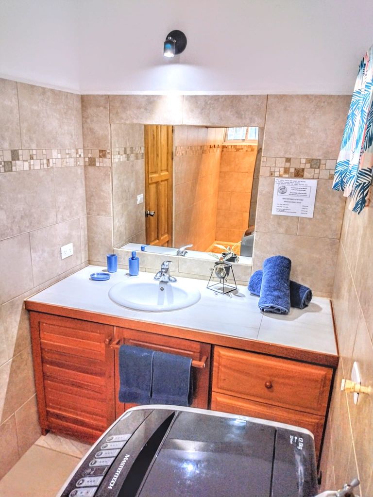 bathroom with washer at Casa ceiba hotel and rental income property for sale at Samara Beach Guanacaste Costa Rica