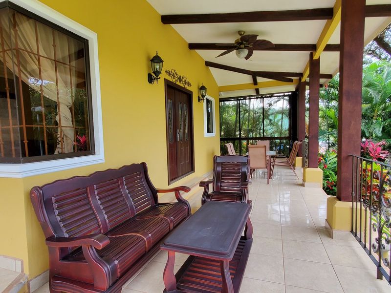 Covered terrace with wooden furniture at Casa Luz, house for sale at Carrillo Beach, Guanacaste, Costa Rica