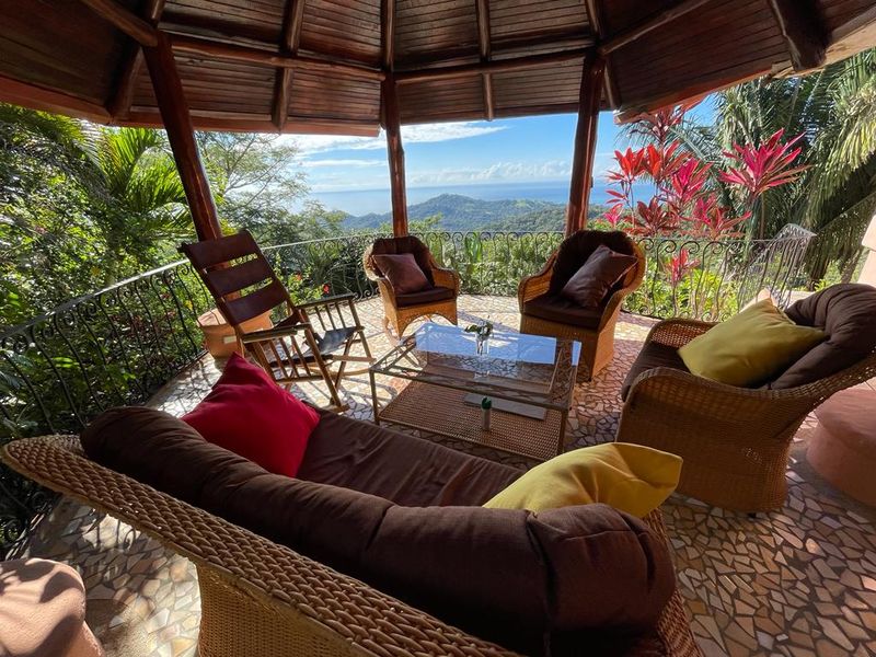 covered deck with lounge area at Villa Amanecer, house for sale at Carrillo Beach, Guanacaste, Costa Rica