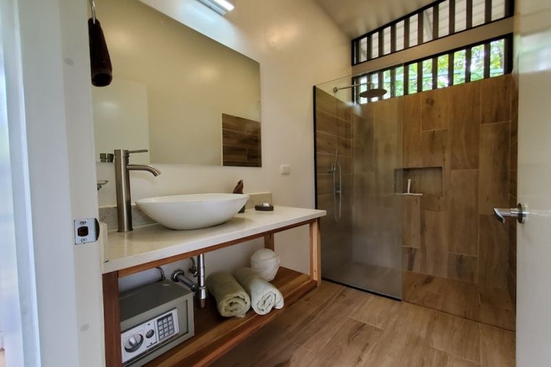 modern bathroom with safe and large bathroom at Lodge Vista Tranquila for sale samara guanacaste costa rica