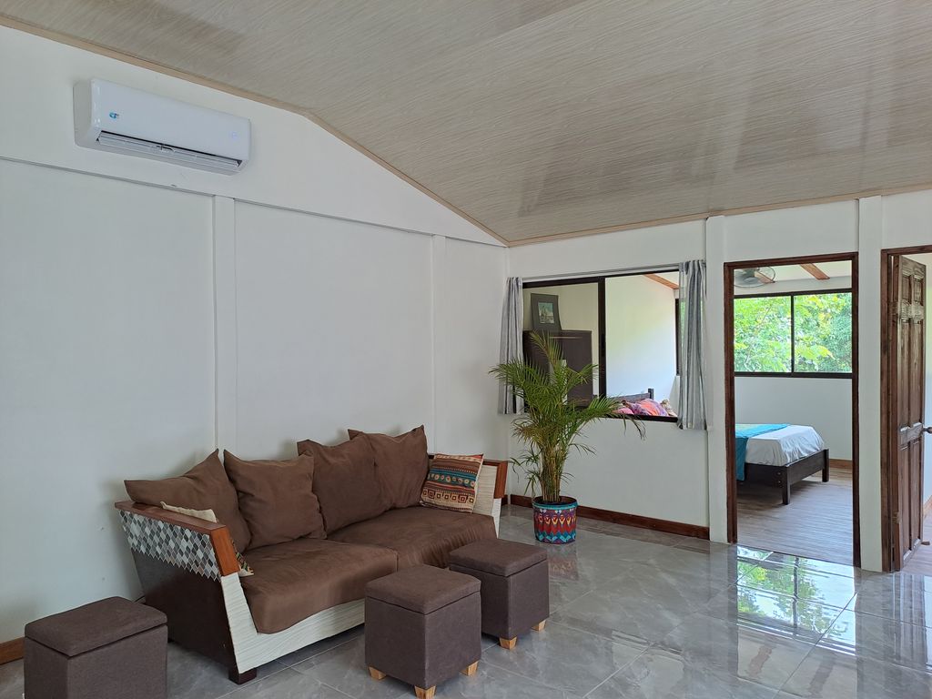 Sofa and air conditioning of Casa Verde house for sale at Samara, Guanacaste, Costa Rica