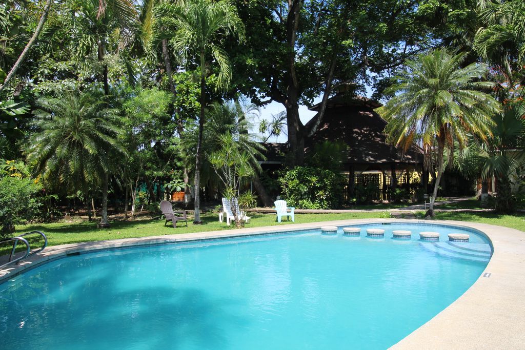 Pool and tropical garden of Samara Central Hotel, business for sale at Samara Beach, Guanacaste, Costa Rica
