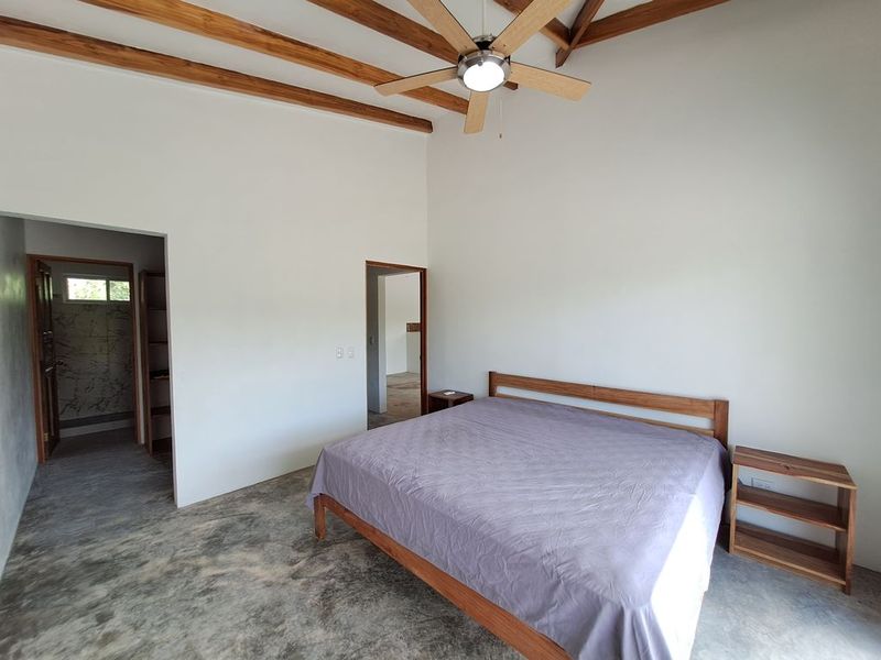 king sized bed in master bedroom of Casa colina mono home for sale samara costa rica