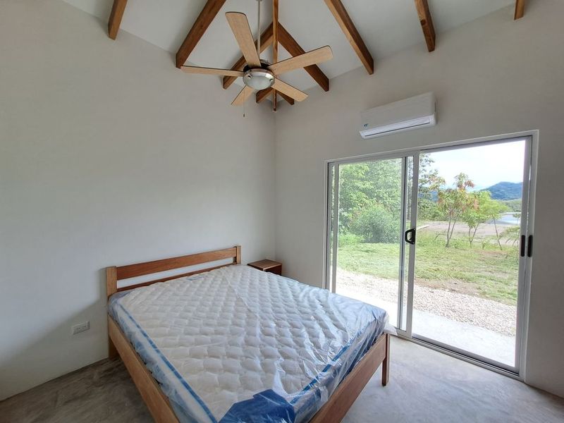 queen sized bed with matress and fan in Casa colina mono home for sale samara costa rica