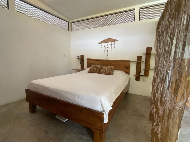 lovely rustic wooden bed at the holistic yoga retreat hotel for sale samara guanacaste costa rica