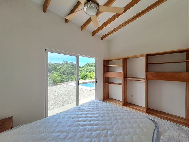 wooden closet and matress in bedroom of Casa colina mono home for sale samara costa rica