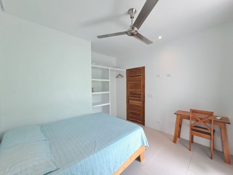 nice bedroom with bed and desk at Casa Mar y sol home for sale samara guanacaste costa rica