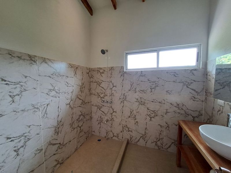 modern bathroom with shower in Casa colina mono home for sale samara costa rica