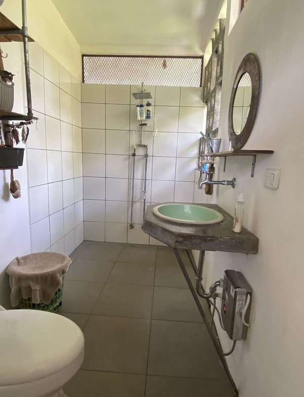 bathroom with sink and shower at the holistic yoga retreat hotel for sale samara guanacaste costa rica