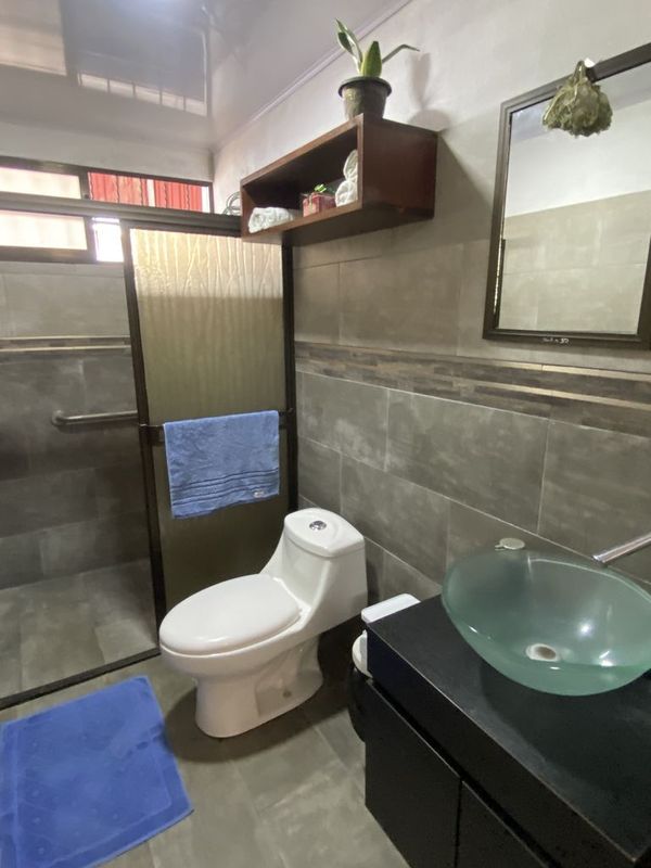 toilet and sink in bathroom of Casa Munoz home for sale samara costa rica