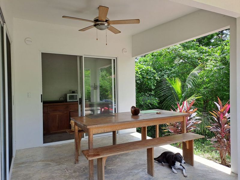 outdoor terrace with table and chairs of Casa colina mono home for sale samara costa rica