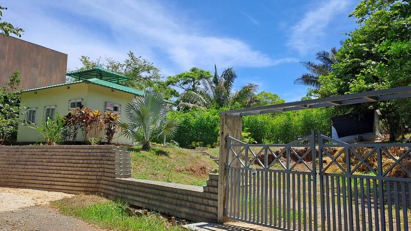 Metal gate and concrete wall house at the back at Casa Pequeña home for sale samara costa rica