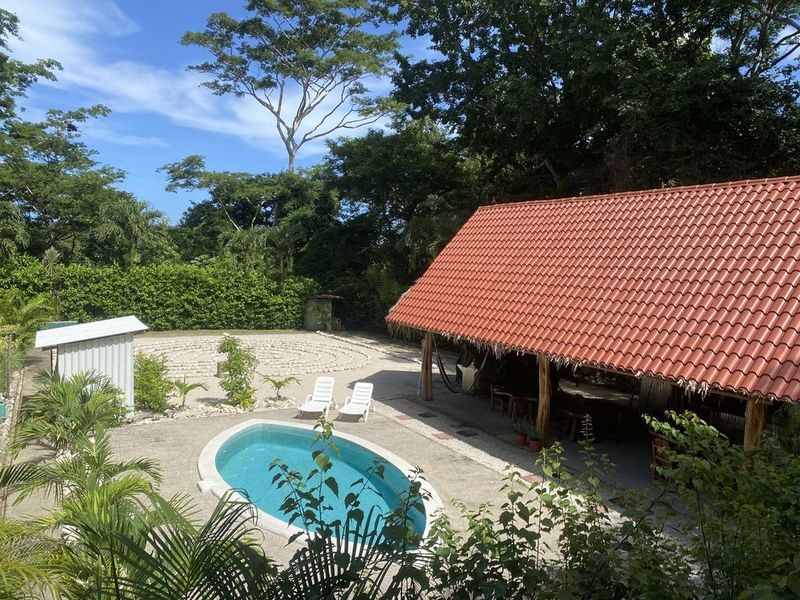 pool and garden view from balcony at the holistic yoga retreat hotel for sale samara guanacaste costa rica