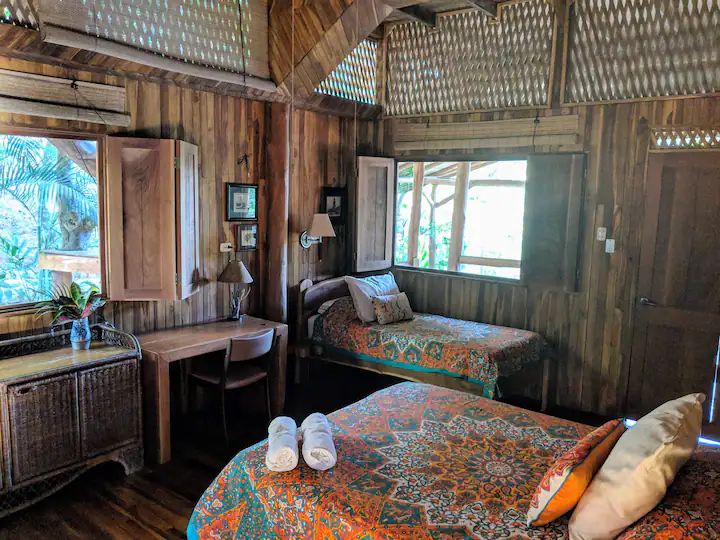 Bedroom with 2 beds and desk at Casa KUPU KUPU hotel for sale samara Guanacaste Costa Rica