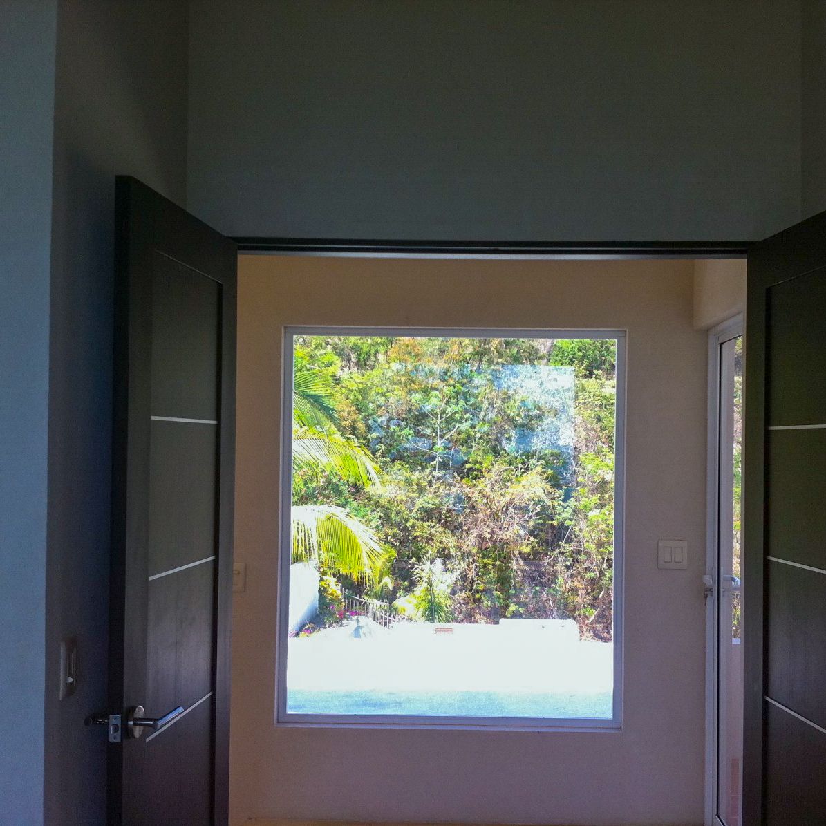 door open showing a window and jungle view Samara Reef Condo for sale Samara Guanacaste Costa rics