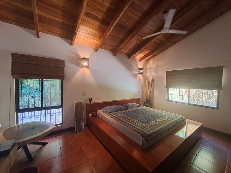 tropical wooden bed at Casa Vista Las Palmas home for sale samara guanacaste costa rica