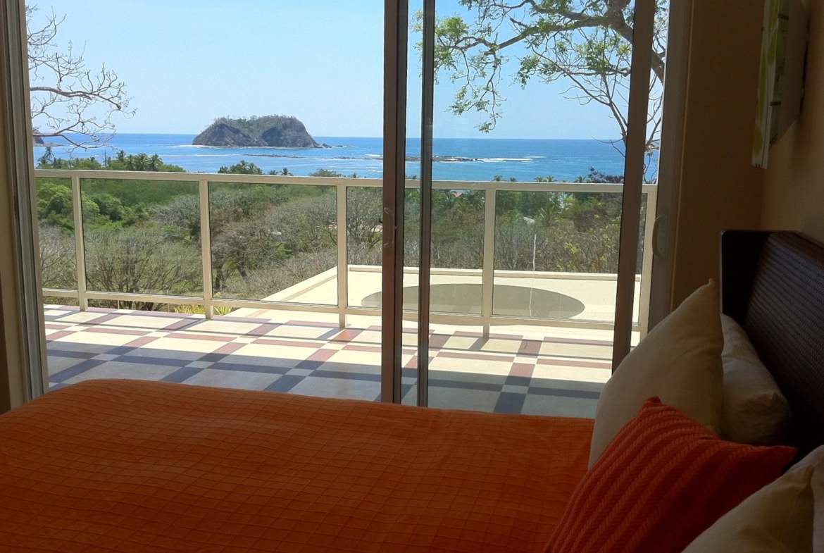 bed with balcony and view on Isla Chora Samara Reef condo for sale Samara Guanacaste Costa Rica